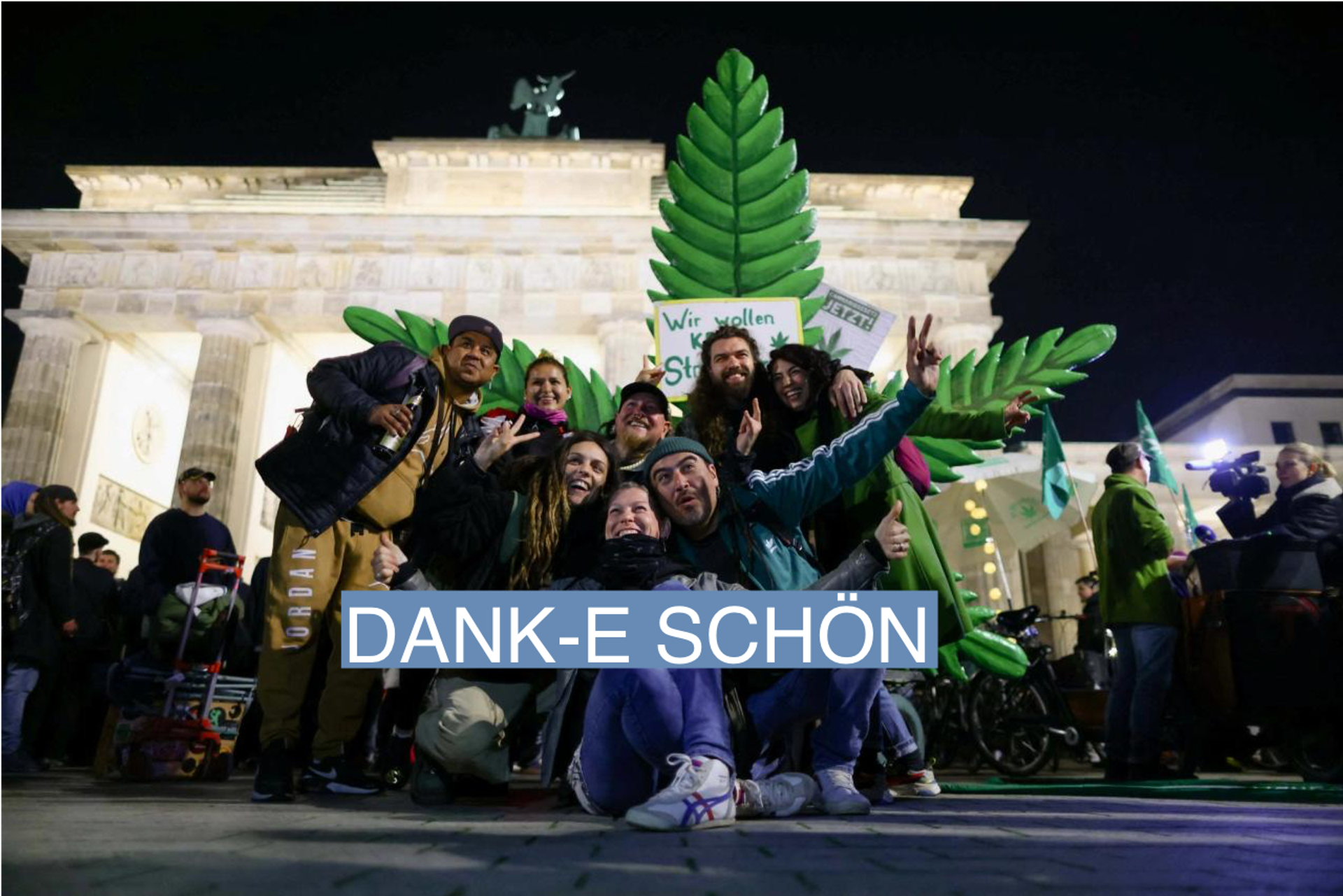 People pose for a picture as Germany's friends of cannabis celebrate the part legalisation of cannabis starting on April 1 with a "smoke in" at Brandenburg Gate in Berlin, Germany,