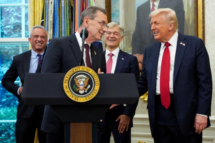 US President Donald Trump reacts with Pfizer CEO Albert Bourla on the day he announces a deal with Pfizer to sell drugs at lower prices.