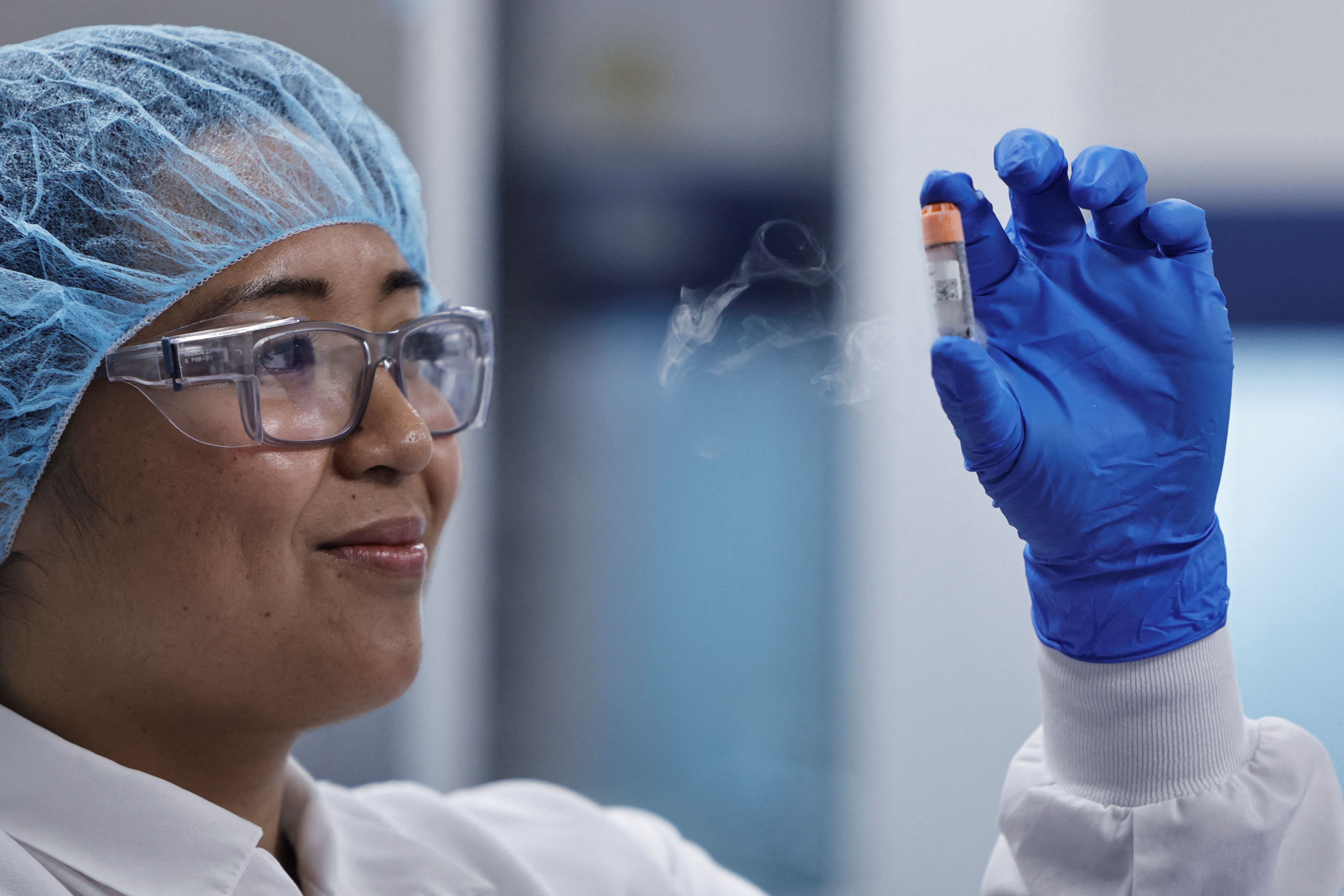 A lab employee holds a vial of frozen chicken cells in the seed lab at the UPSIDE Foods plant, where lab-grown meat is cultivated, in Emeryville, California