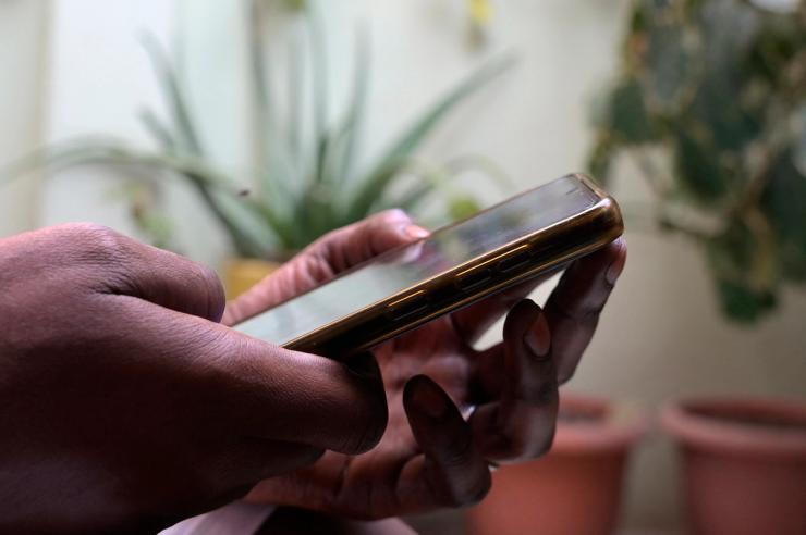 A person holds a mobile phone in Dakar.