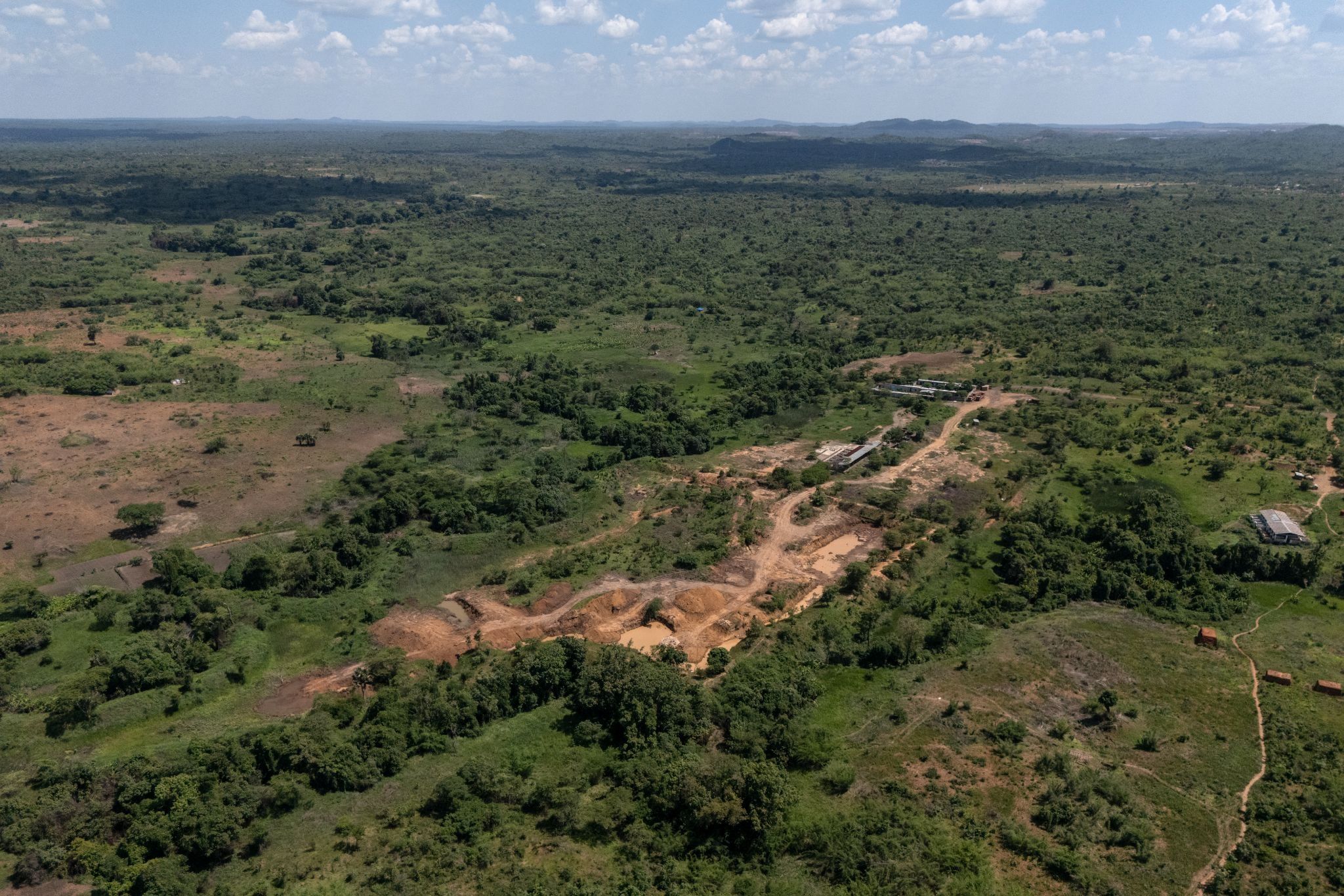 Aerial view showing a mining site next to a forest reserve in Likasi.
