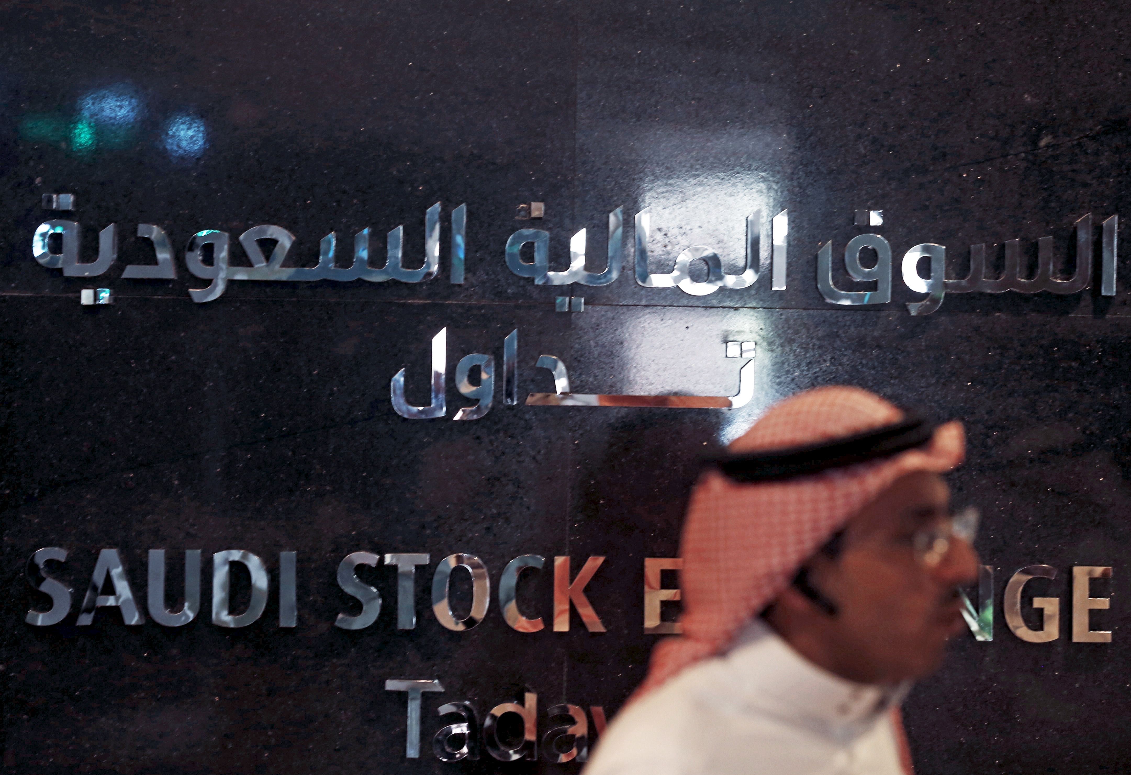 Man walks past the Saudi Stock Exchange