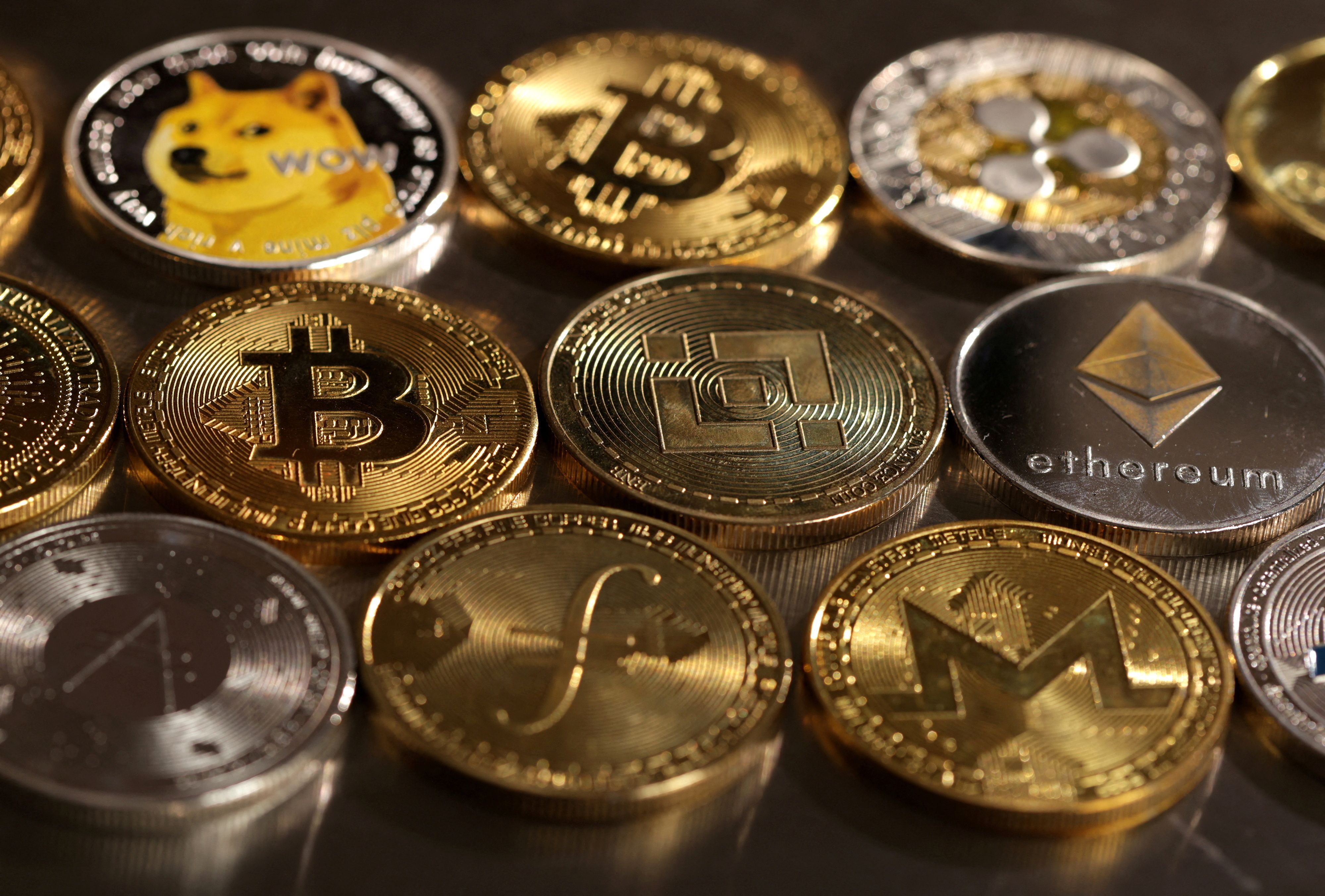 Representations of cryptocurrencies are seen in this illustration.