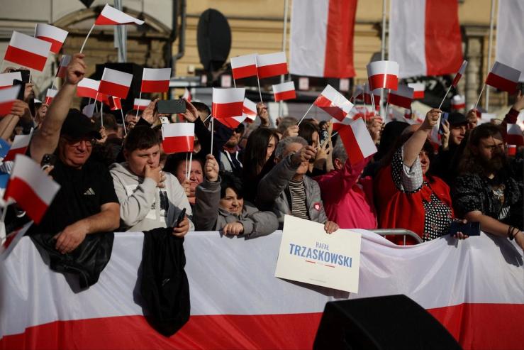 Supporters of Civic Coalition presidential candidate Warsaw Mayor Rafal Trzaskowski hold flags during an election rally.