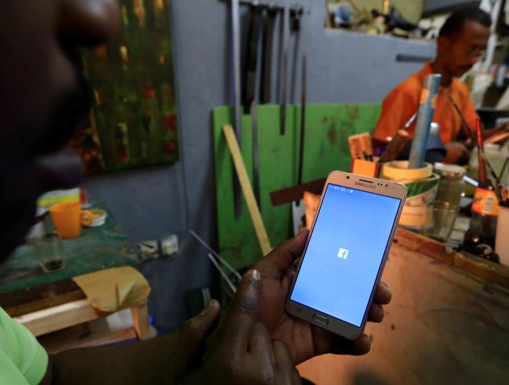 A person using a smartphone in Khartoum, Sudan.