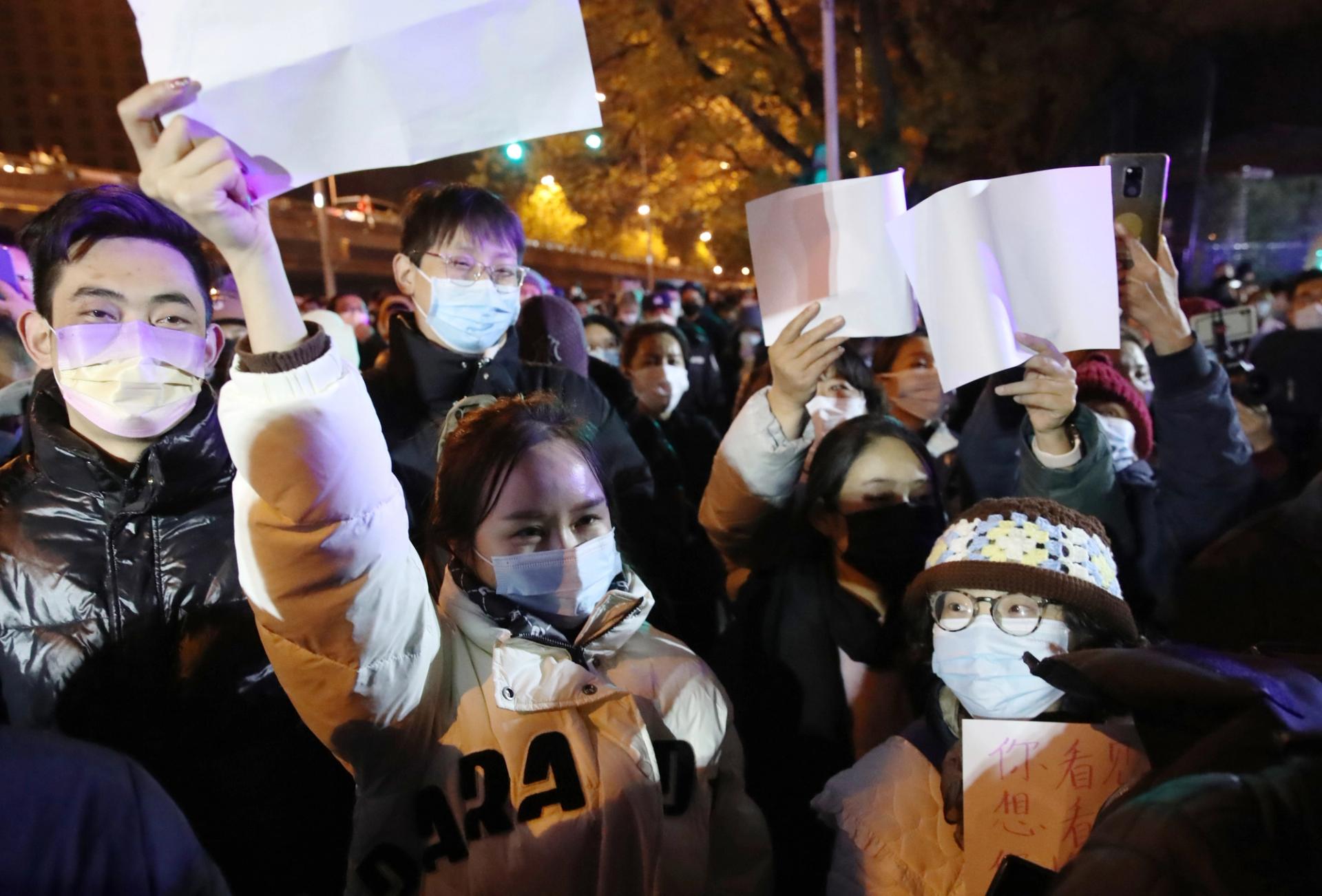 People held white paper to express their protest against Zero-Covid policy and shouted, “No more PCR tests, we need freedom.”