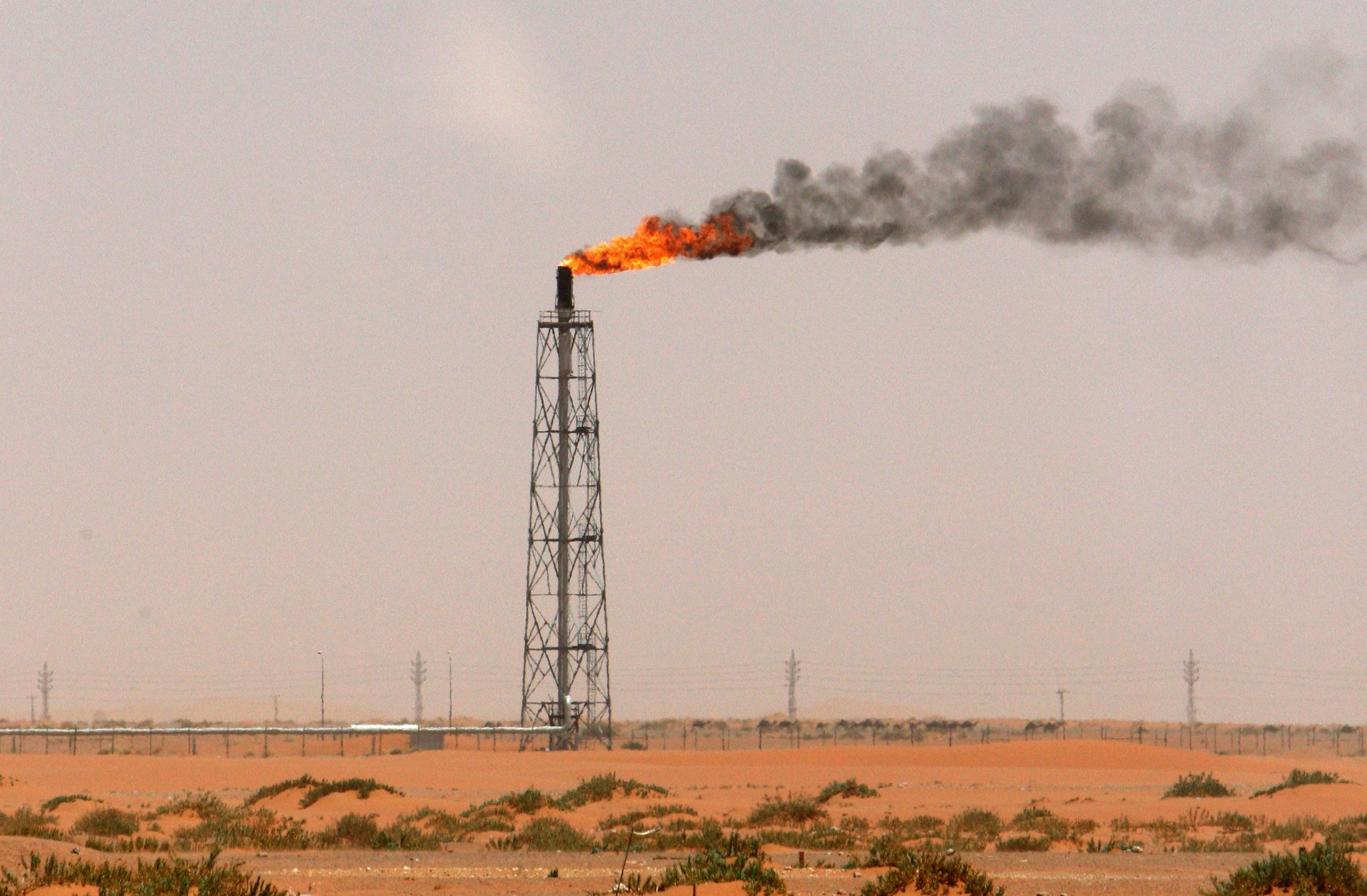 A gas flame is seen in the desert near the Khurais oilfield.