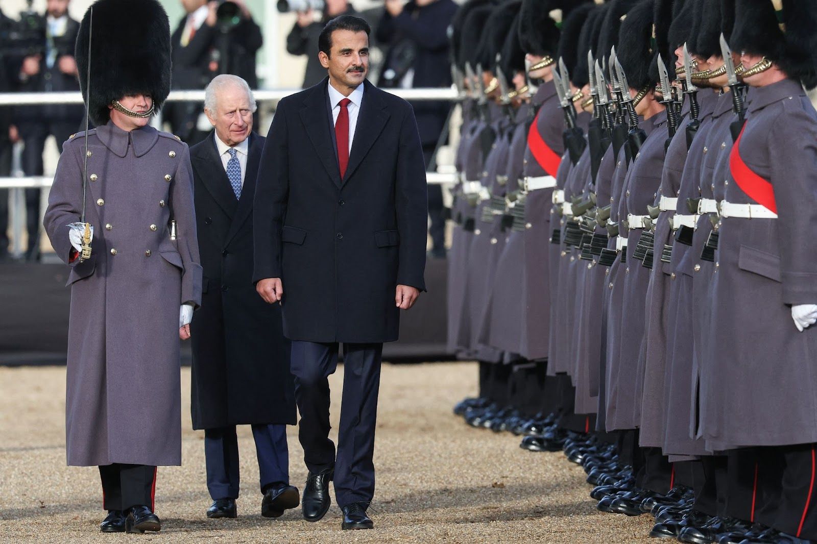 Britain’s King Charles, walks with Qatari Emir Sheikh Tamim bin Hamad al-Thani at a ceremonial welcome