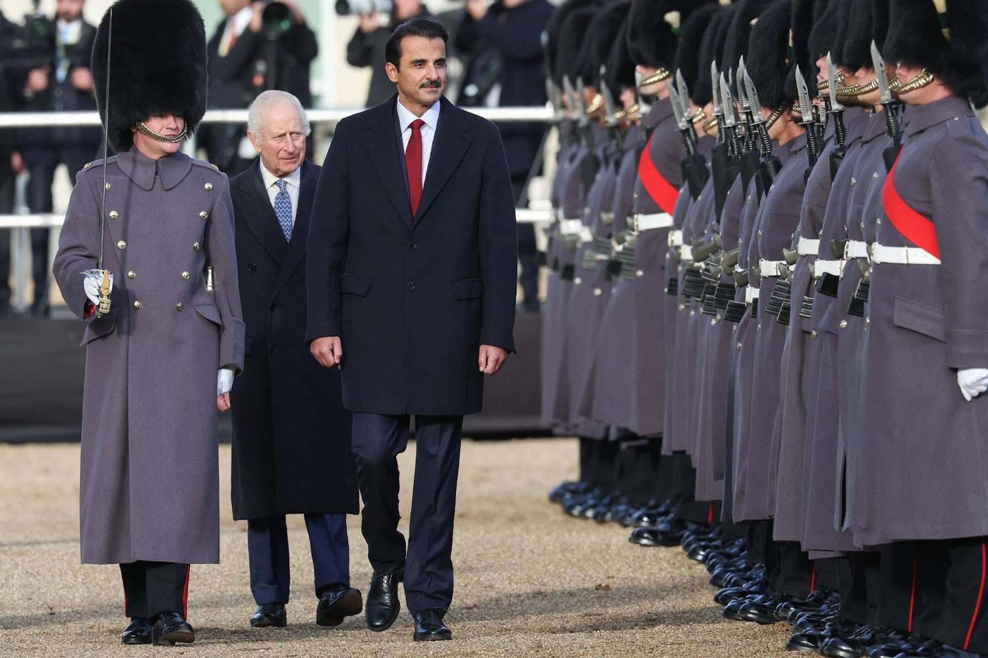 Britain’s King Charles, walks with Qatari Emir Sheikh Tamim bin Hamad al-Thani at a ceremonial welcome