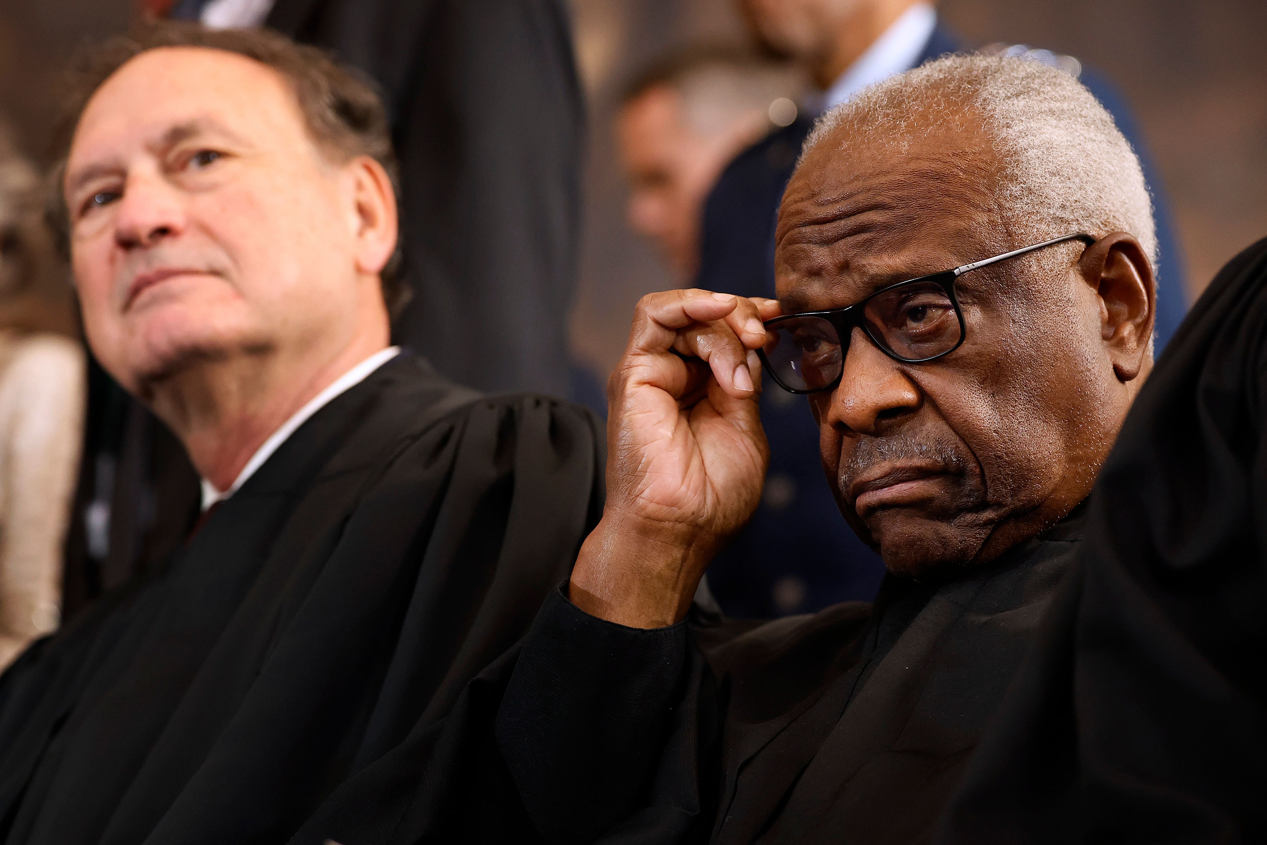 U.S. Supreme Court Associate Justices Samuel Alito (L) and Clarence Thomas wait for their opportunity to leave the stage at the conclusion of the inauguration ceremonies in the Rotunda of the U.S. Capitol on January 20, 2025 in Washington, DC
