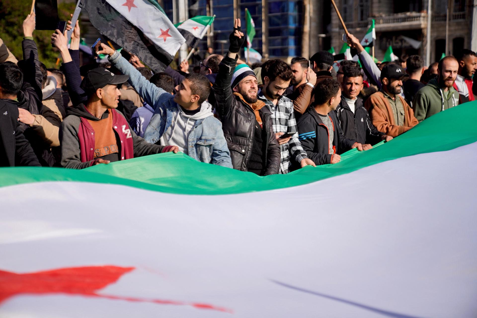 Syrian citizens celebrating the fall of President Bashar al-Assad.