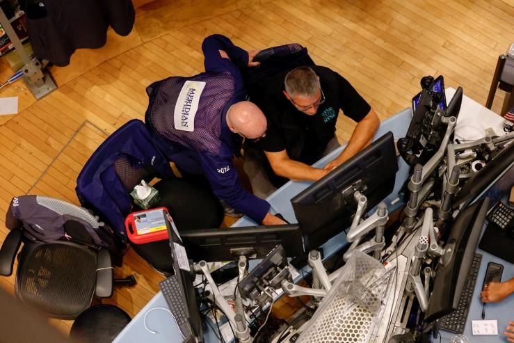 Traders work on the floor of the New York Stock Exchange (NYSE) in New York City, U.S.