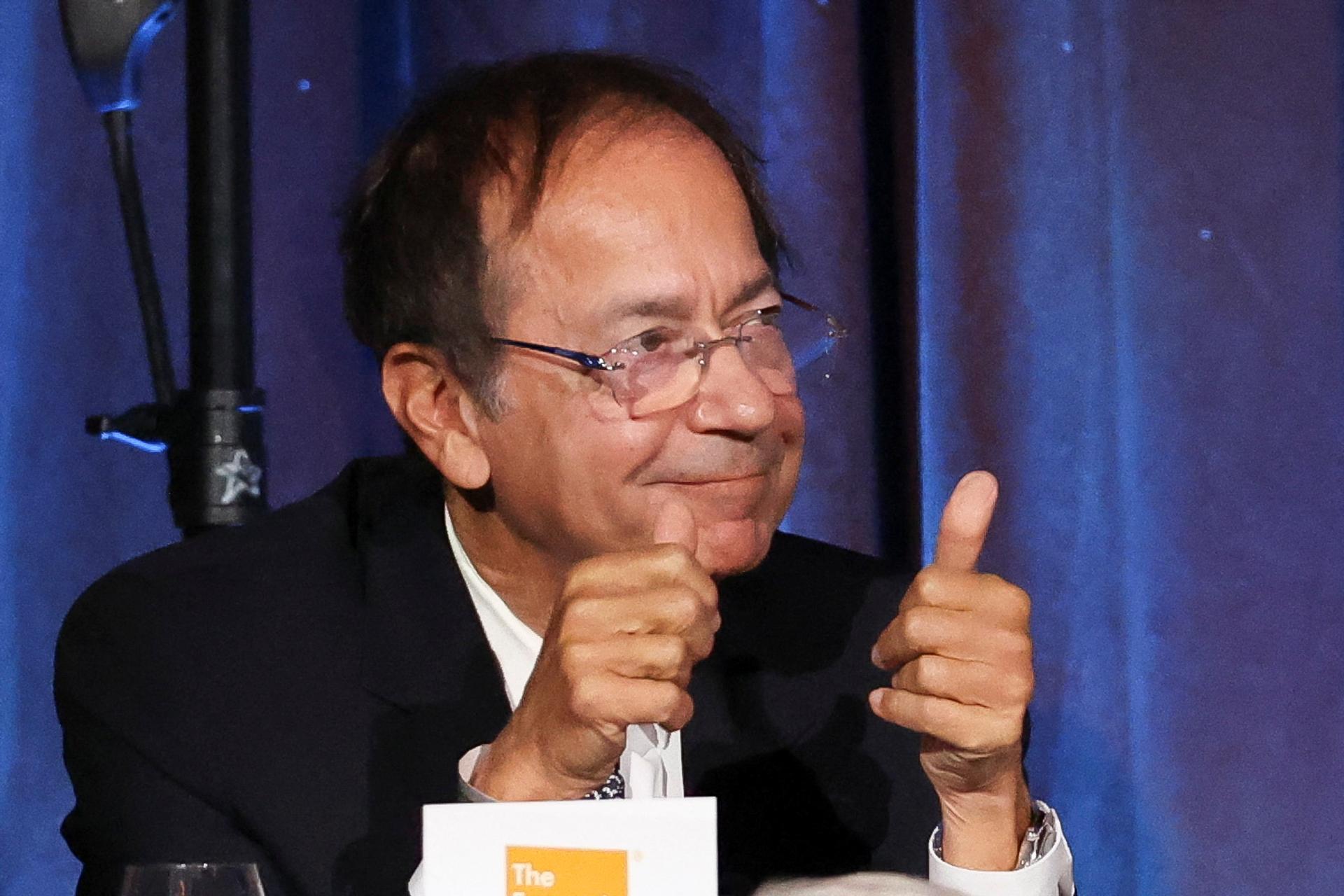 John Paulson gives a thumbs up after asking a question as Donald Trump addresses the Economic Club of New York in September