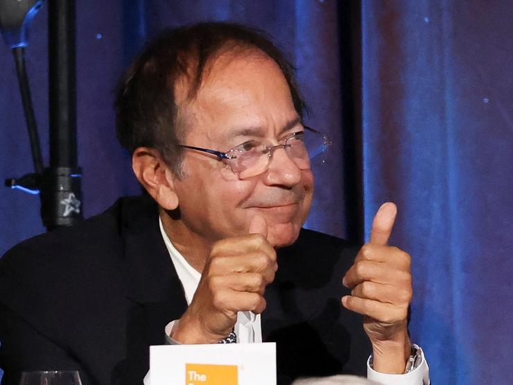 John Paulson gives a thumbs up after asking a question as Donald Trump addresses the Economic Club of New York in September