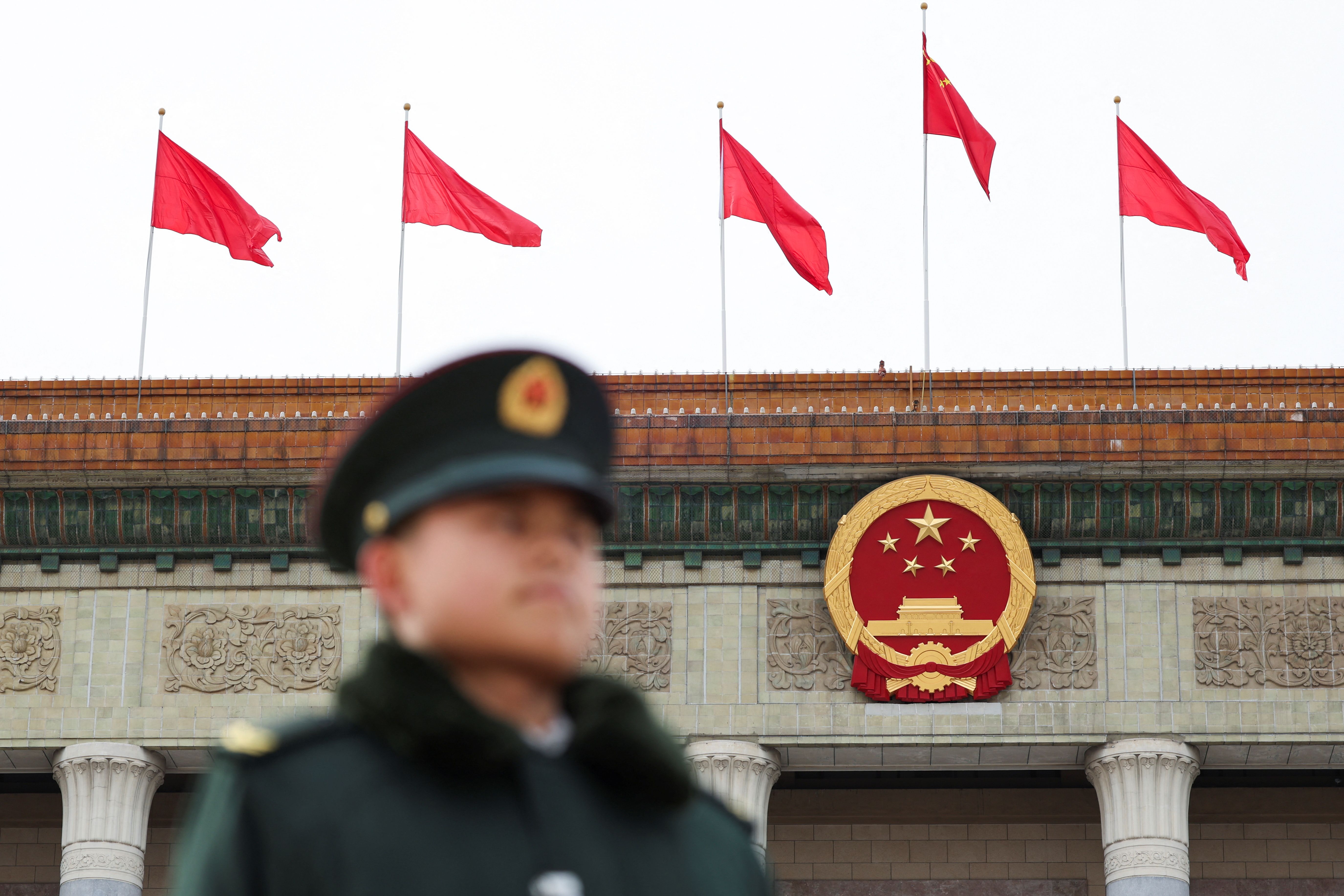 A military officer stands guard at the open space in front of the Great Hall of the People, ahead of the National People’s Congress (NPC) session.