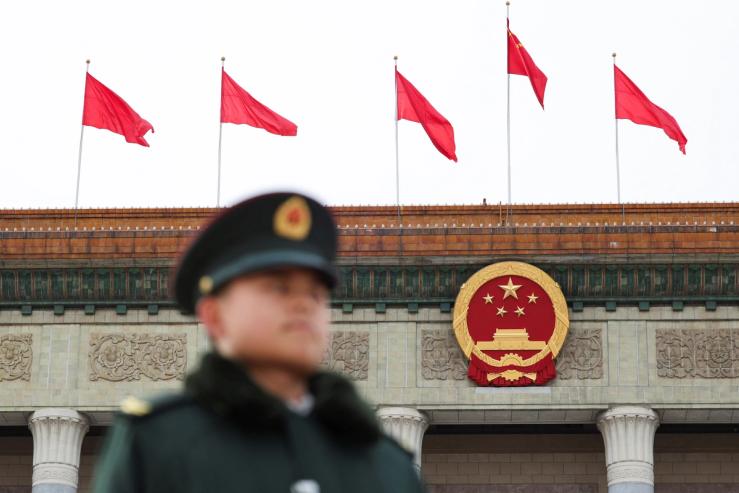 A military officer stands guard at the open space in front of the Great Hall of the People, ahead of the National People’s Congress (NPC) session.
