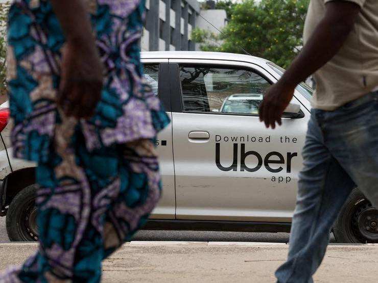 People walk past an Uber car as in Lagos, Nigeria, March 18, 2026.