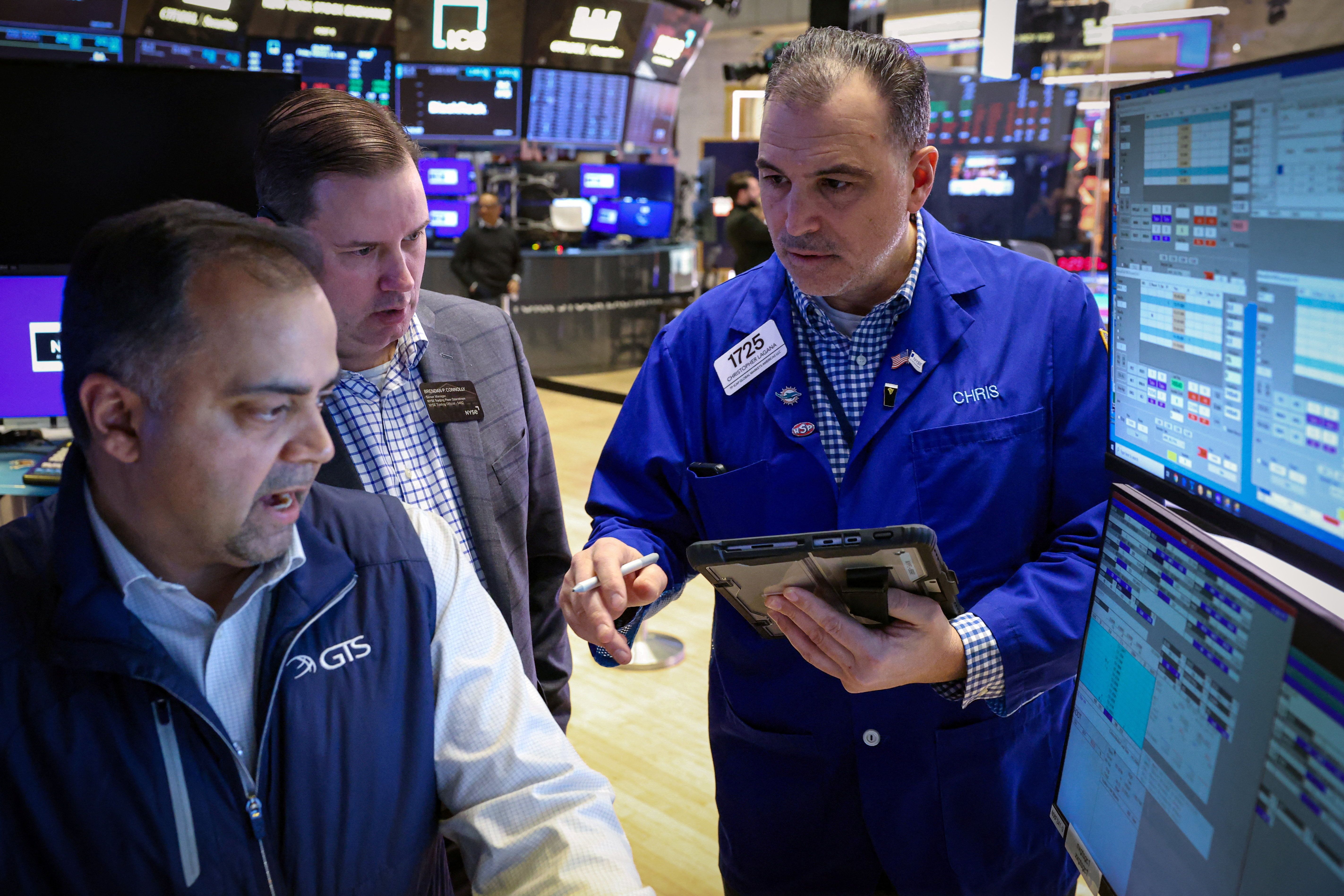 Traders work on the floor at the New York Stock Exchange