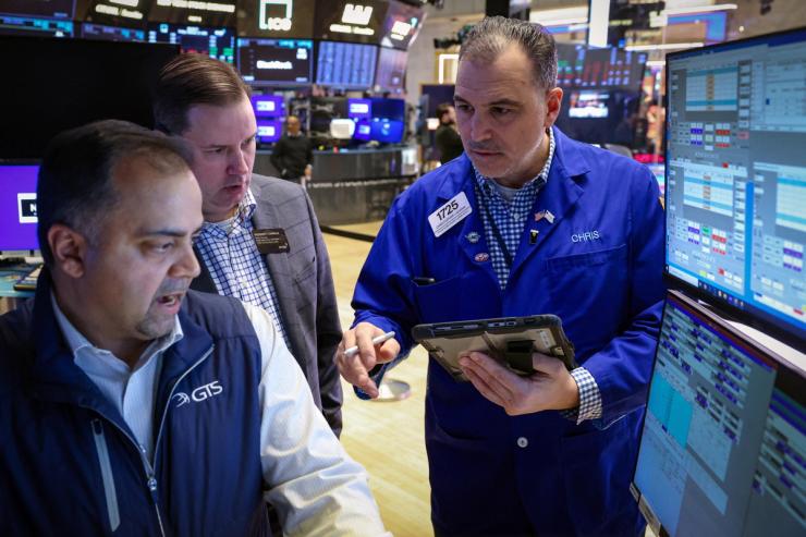Traders work on the floor at the New York Stock Exchange