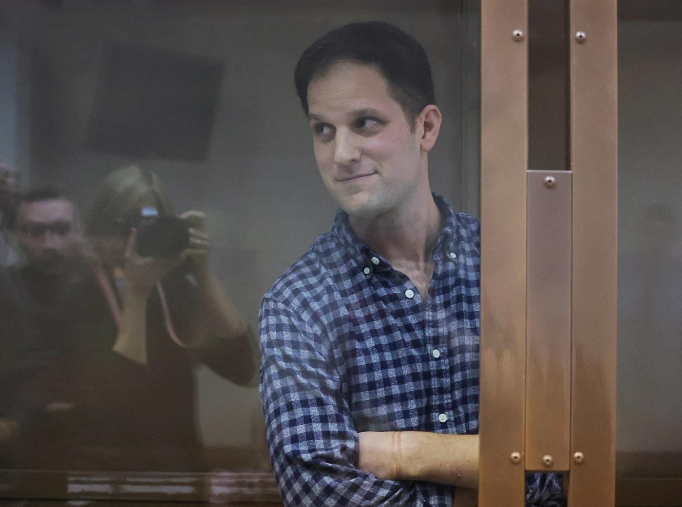 Wall Street Journal reporter Evan Gershkovich, who was detained in March while on a reporting trip and charged with espionage, stands behind a glass wall of an enclosure for defendants before a court hearing to consider an appeal against his detention, in Moscow, Russia April 18, 2023.