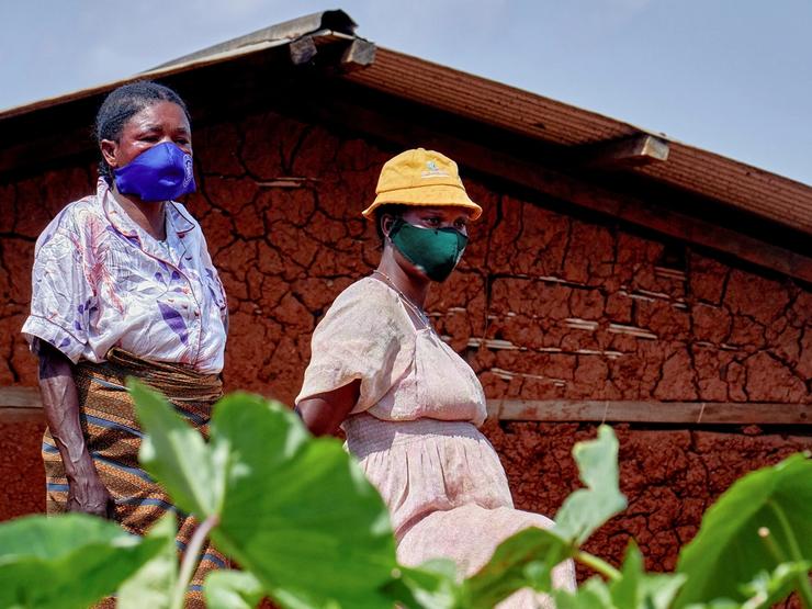 Congolese women stand near the house of a man who died of Ebola