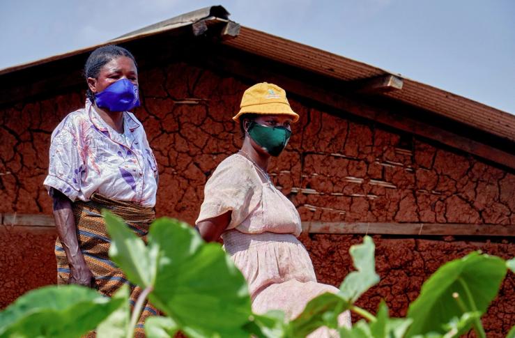 Congolese women stand near the house of a man who died of Ebola