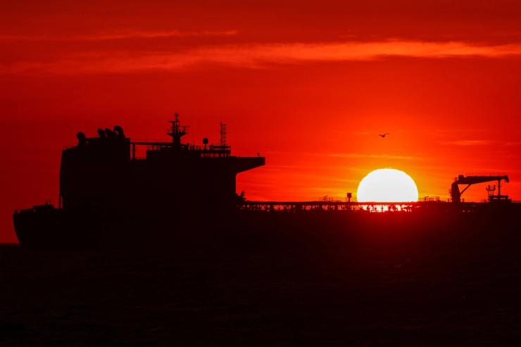 An oil tanker anchors near the oil hub of the port of Fos-Lavera at sunset near Marseille.