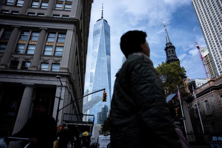 People walk around the Financial District in NYC.