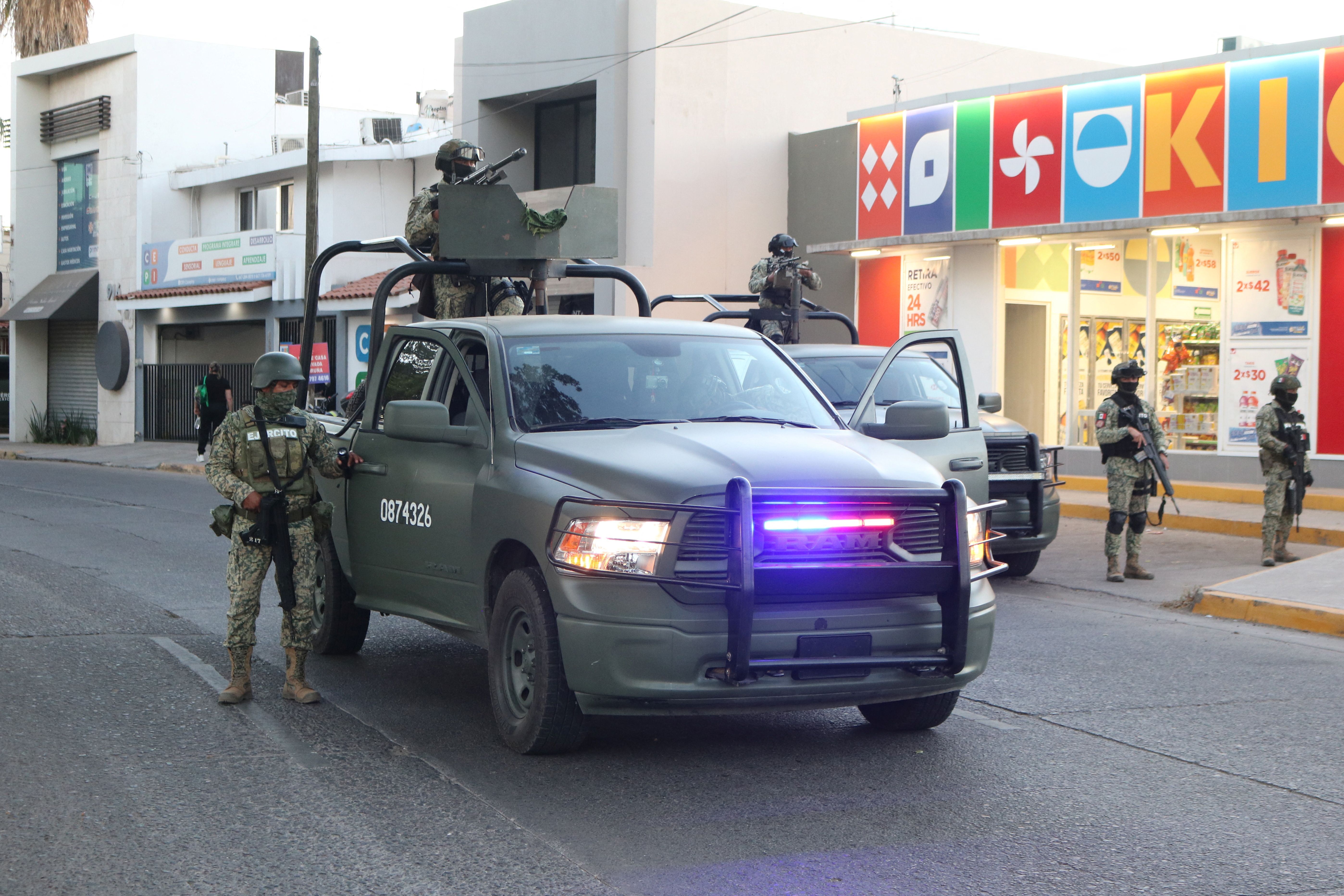 Members of the Mexican army stand guard in the area where members of the Sinaloa Cartel were detained.