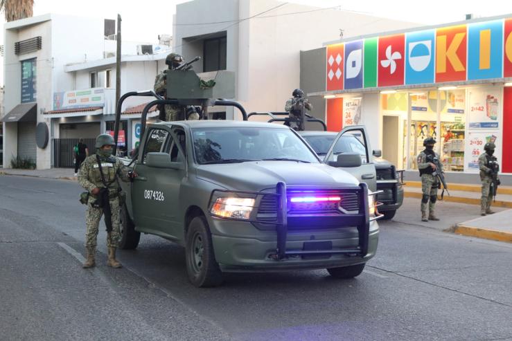 Members of the Mexican army stand guard in the area where members of the Sinaloa Cartel were detained.