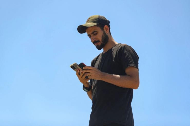 Palestinians attempt to access the internet using eSIMs, in Gaza City