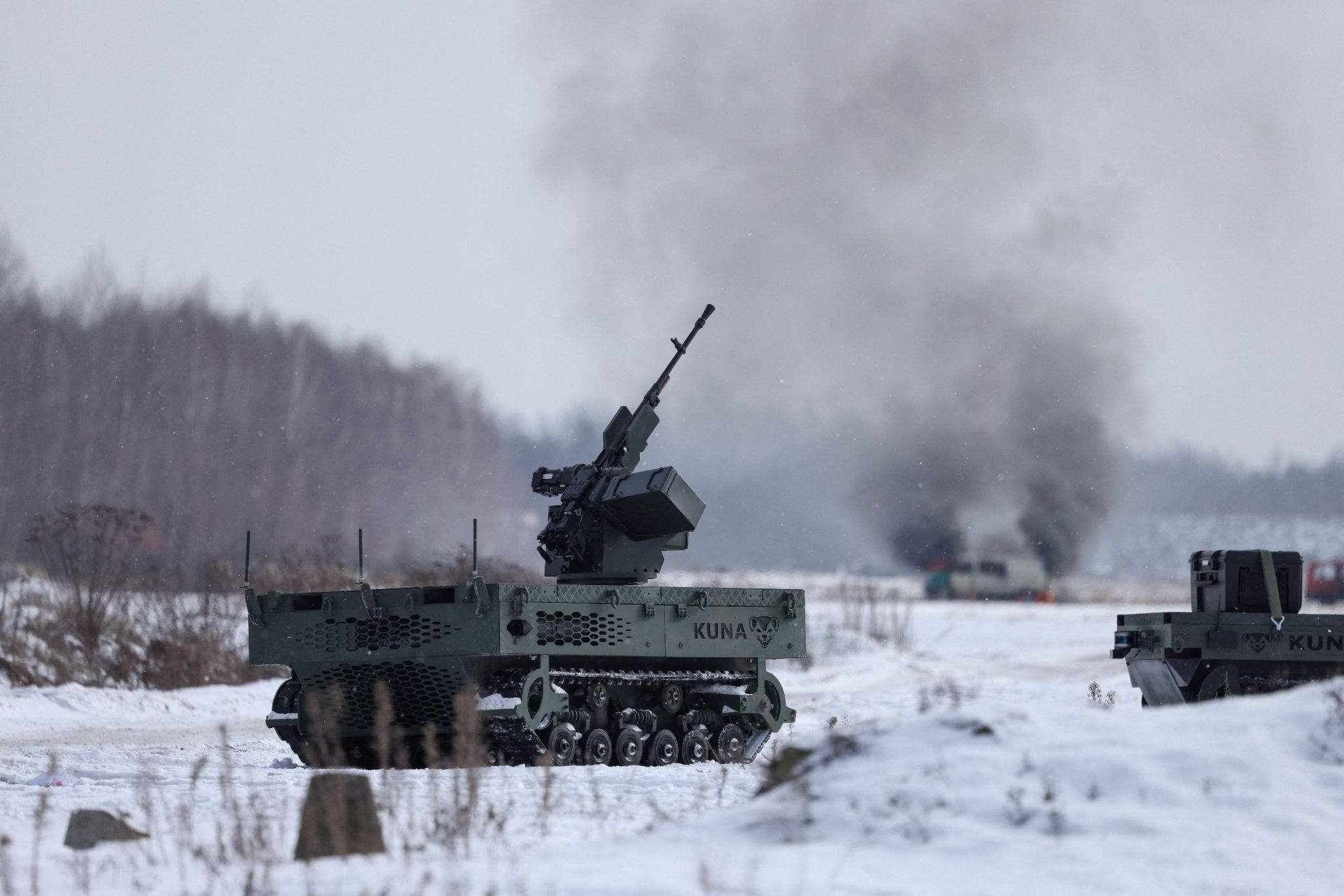 A Polish-made unmanned tracked ground vehicle with a mounted machine gun during a weapons test. 