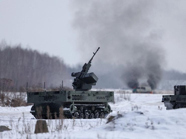 A Polish-made unmanned tracked ground vehicle with a mounted machine gun during a weapons test.