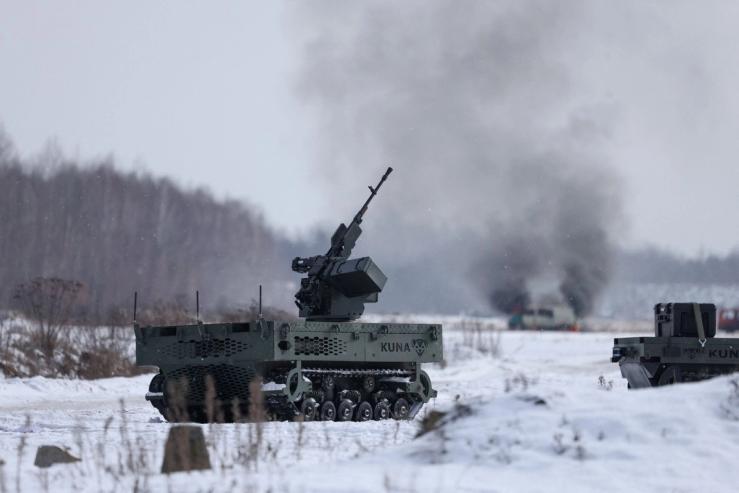 A Polish-made unmanned tracked ground vehicle with a mounted machine gun during a weapons test.