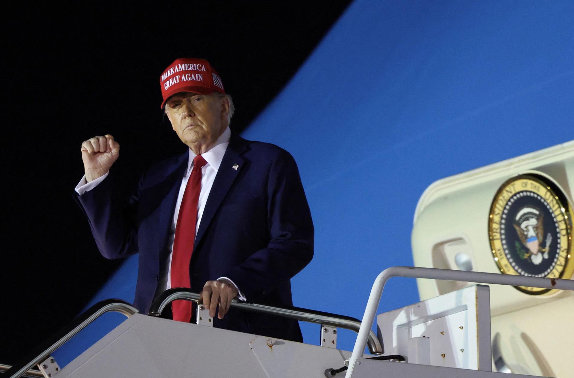 US President Donald Trump disembarks from Air Force One.