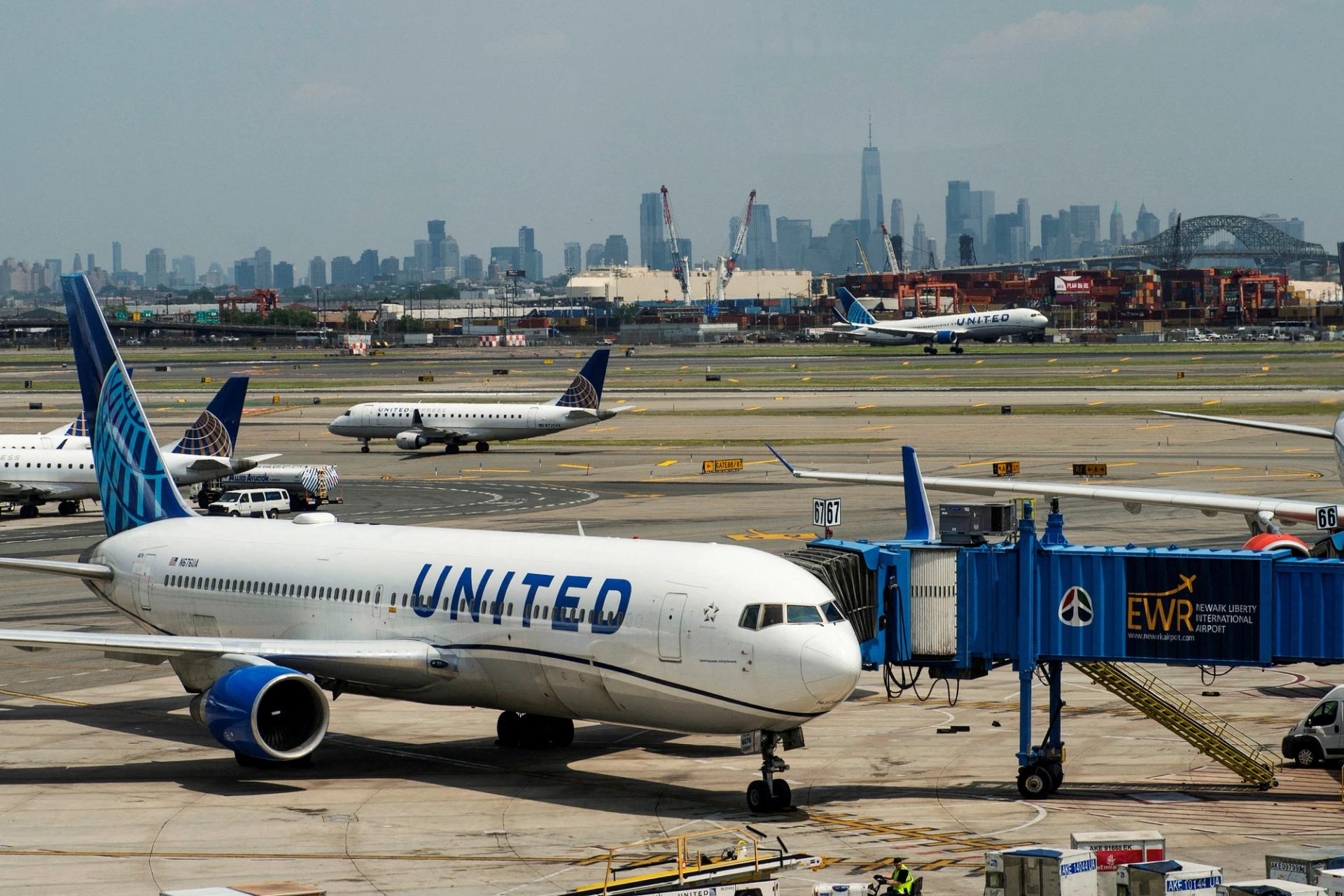 The One World trace Center and the New York skyline are seen while United Airlines planes use the tarmac at Newark Liberty International Airport