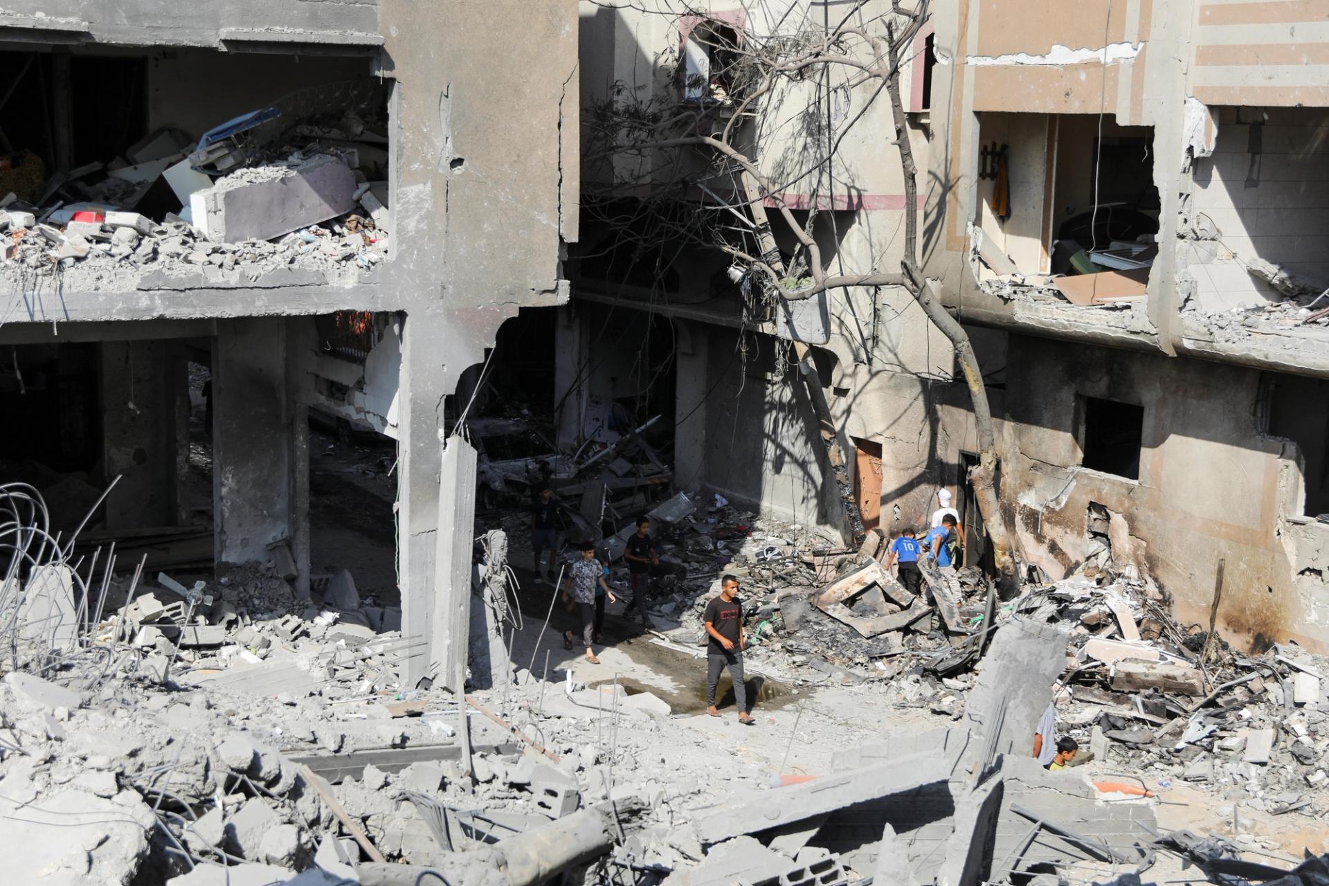 Men walk among debris, aftermath of Israeli strikes at the area, where Israeli hostages were rescued on Saturday, as Palestinian death toll rises to 274, amid the Israel-Hamas conflict, in Nuseirat refugee camp in the central Gaza Strip, June 9, 2024. REUTERS/Abed Khaled