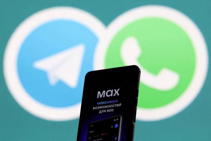 A web page of the Russian messenger app MAX displayed on a smartphone next to a screen showing the logo of WhatsApp and Telegram applications.