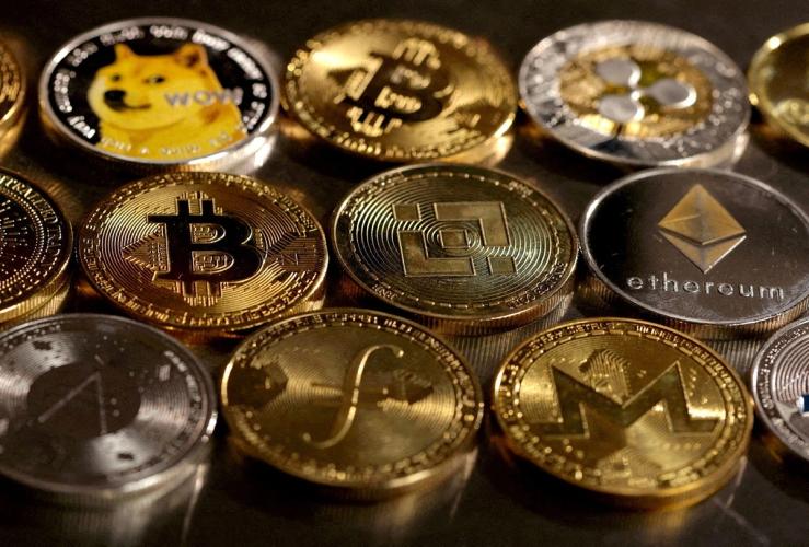 Illustration shows representations of cryptocurrencies.