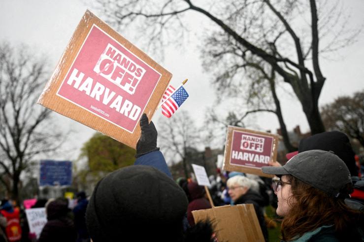 Demonstrators rally on Cambridge Common in a protest organized by the City of Cambridge calling on Harvard leadership to resist interference at the university by the federal government in Cambridge, Massachusetts, U.S. April 12, 2025.