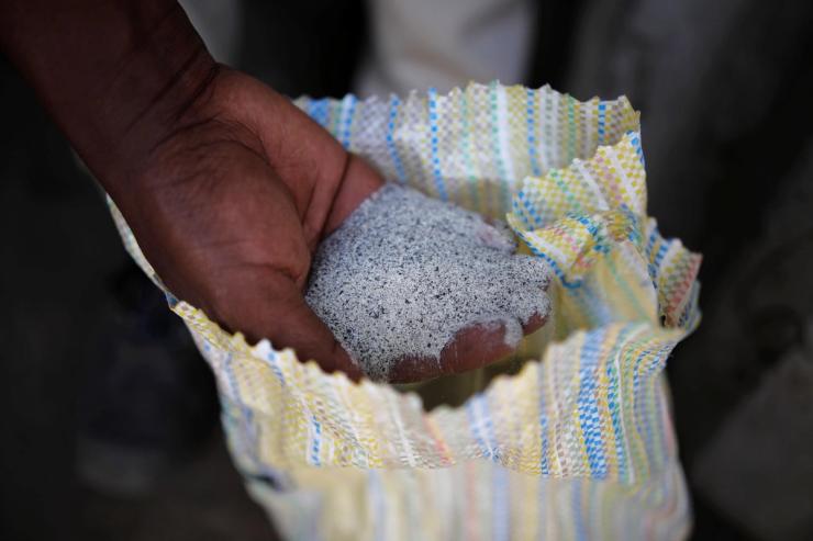A man displays coltan ore at the SMB mine near the town of Rubaya in the Eastern Democratic Republic of Congo, August 13, 2019.