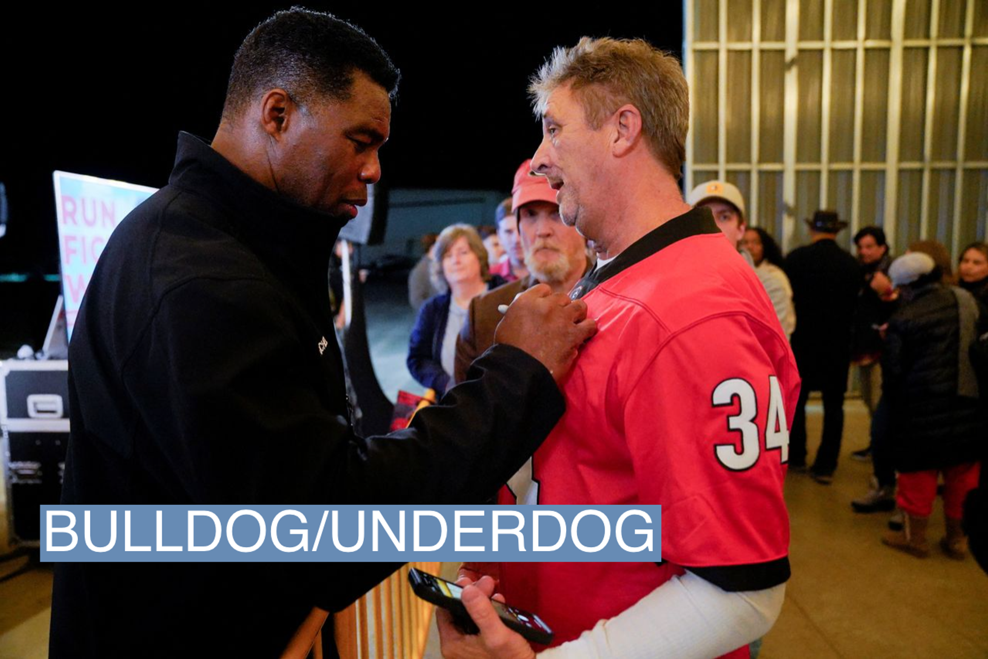 U.S. Senate candidate sign's a supporter's football jersey in Georgia.