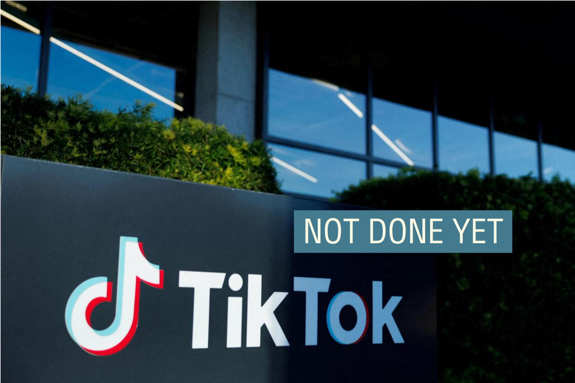 A TikTok logo in front of a building