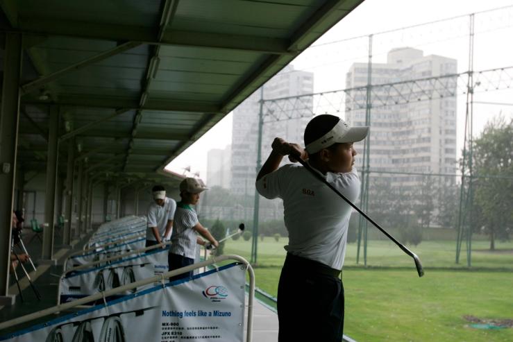 Young Chinese golf players practise at Chaoyang Kosaido Golf Club in Beijing.