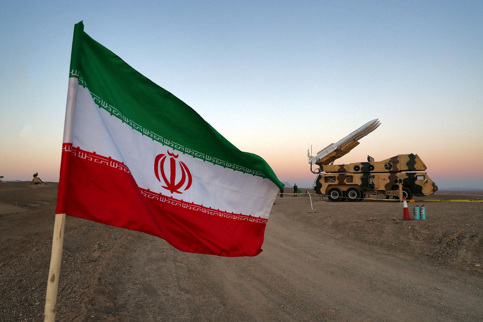 FILE PHOTO: An Iranian flag is pictured near a missile during a military drill, with the participation of Iran’s Air Defense units, Iran October 19, 2020. WANA (West Asia News Agency) via REUTERS /File Photo