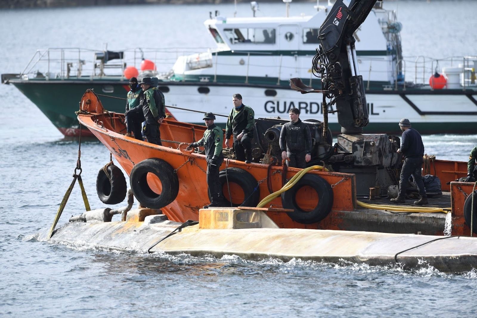A narco-sub is hauled into port