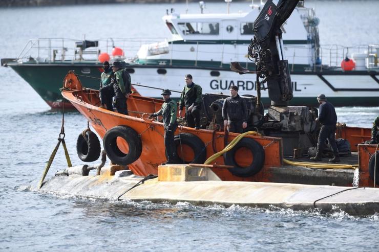 A narco-sub is hauled into port