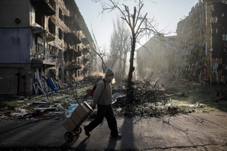 A resident walks near apartment buildings damaged by a Russian military strike, amid Russia’s attack on Ukraine, in the frontline town of Kostiantynivka in Donetsk region, Ukraine
