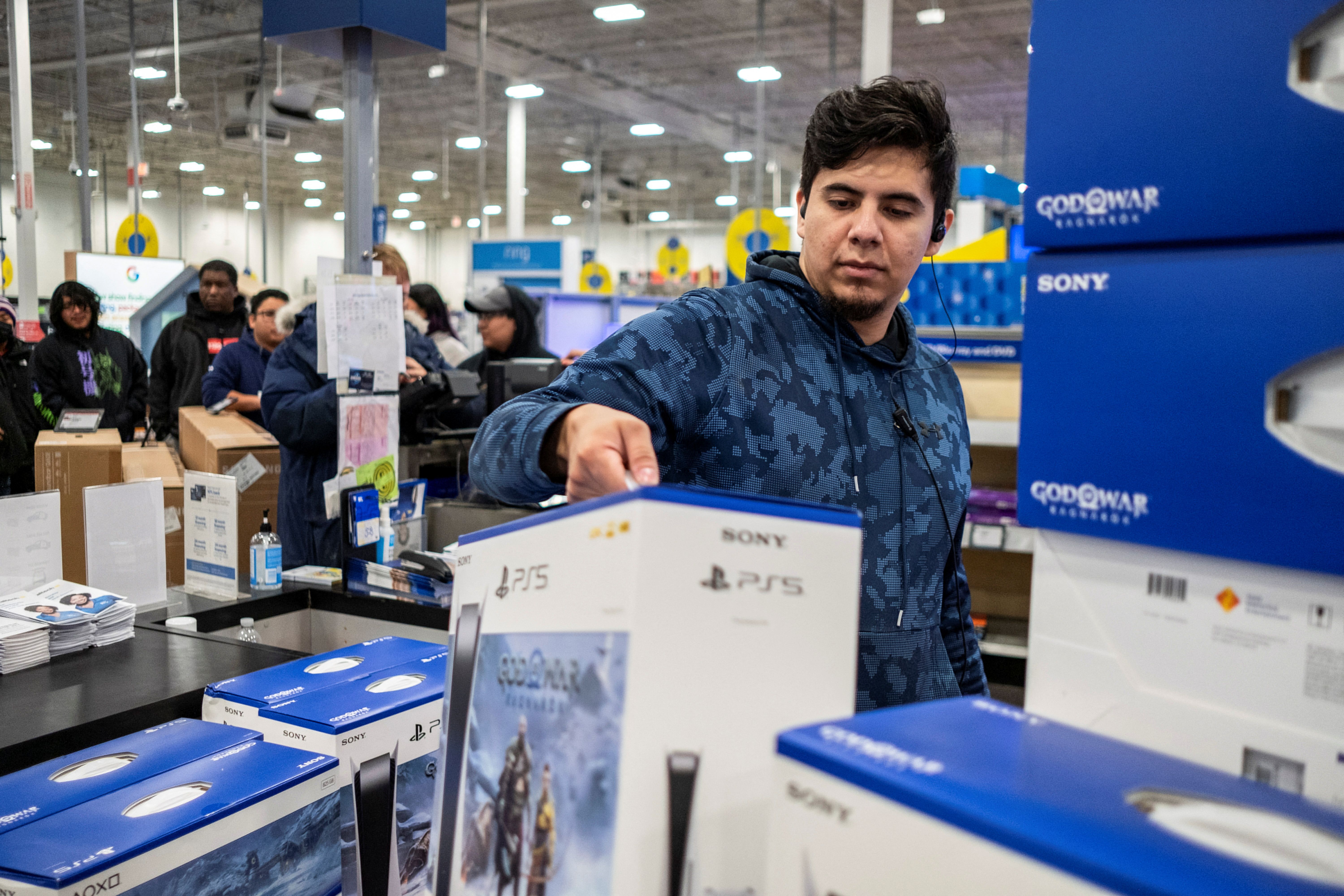 A worker holds a Playstation 5 at a Best Buy store during Black Friday sales in Chicago, Illinois
