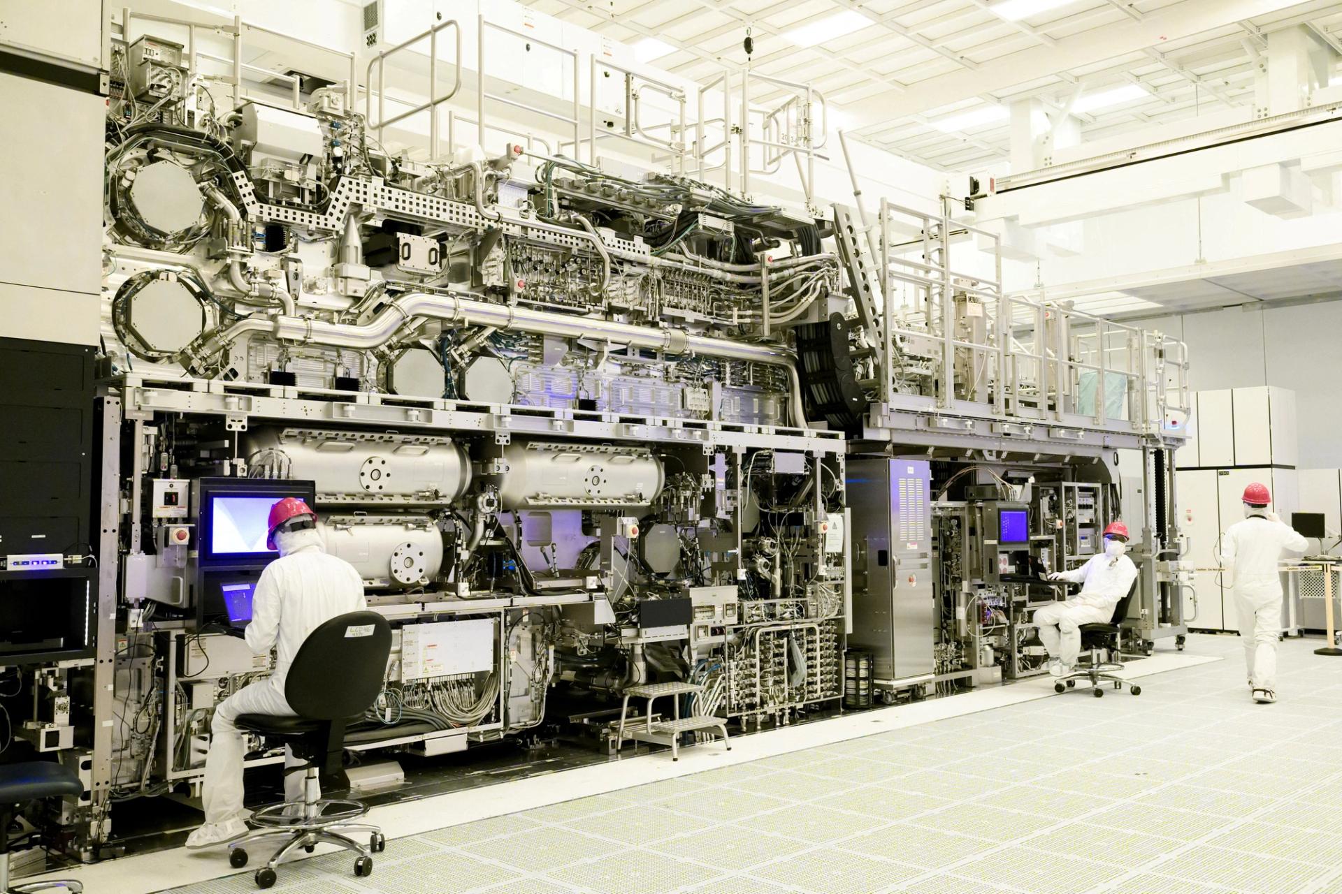 Workers are seen in front of a “High NA EUV” lithography system at an Intel facility in Hillsboro, Oregon